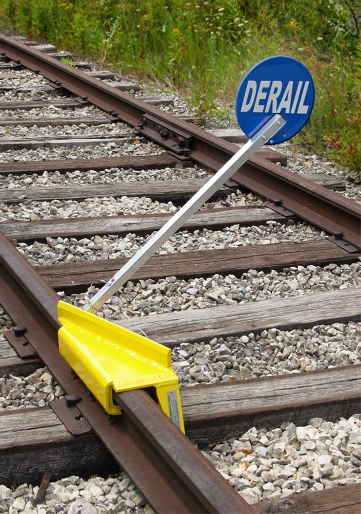 Sabertooth Left Throw Derail - Use on wooden ties only. Tie spacing: 18"-24" on center. Derails freight cars and all sizes of locomotives operating at switching speeds.  Height above rail 2.75". Fits rail from 90 to 141 lbs. per yd.  Weighs 35 lbs.